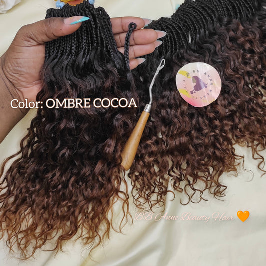 Ombre cocoa hair extensions with a crochet hook on a white background with flowers.