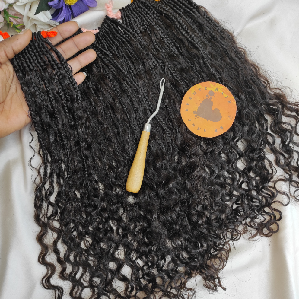 Curly hair extensions with a crochet hook and wooden pin on a white background