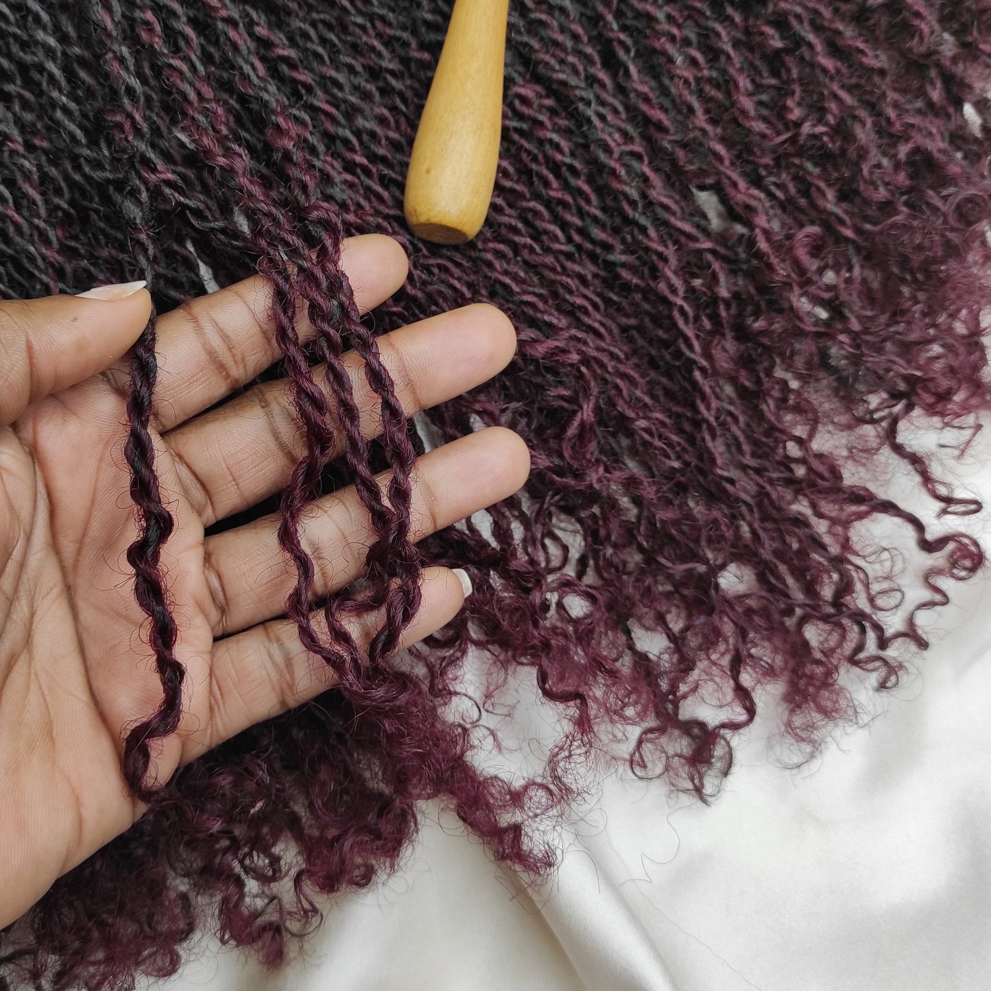 Zoomed-in texture of Afro Kinky human hair twists with finger-coiled ends