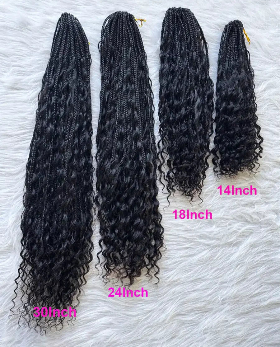 A collection of braided wigs in various sizes displayed on a white surface, with tags indicating different wig lengths.