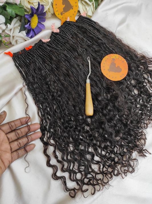 Black braided hair with a crochet hook and decorative elements on a white background