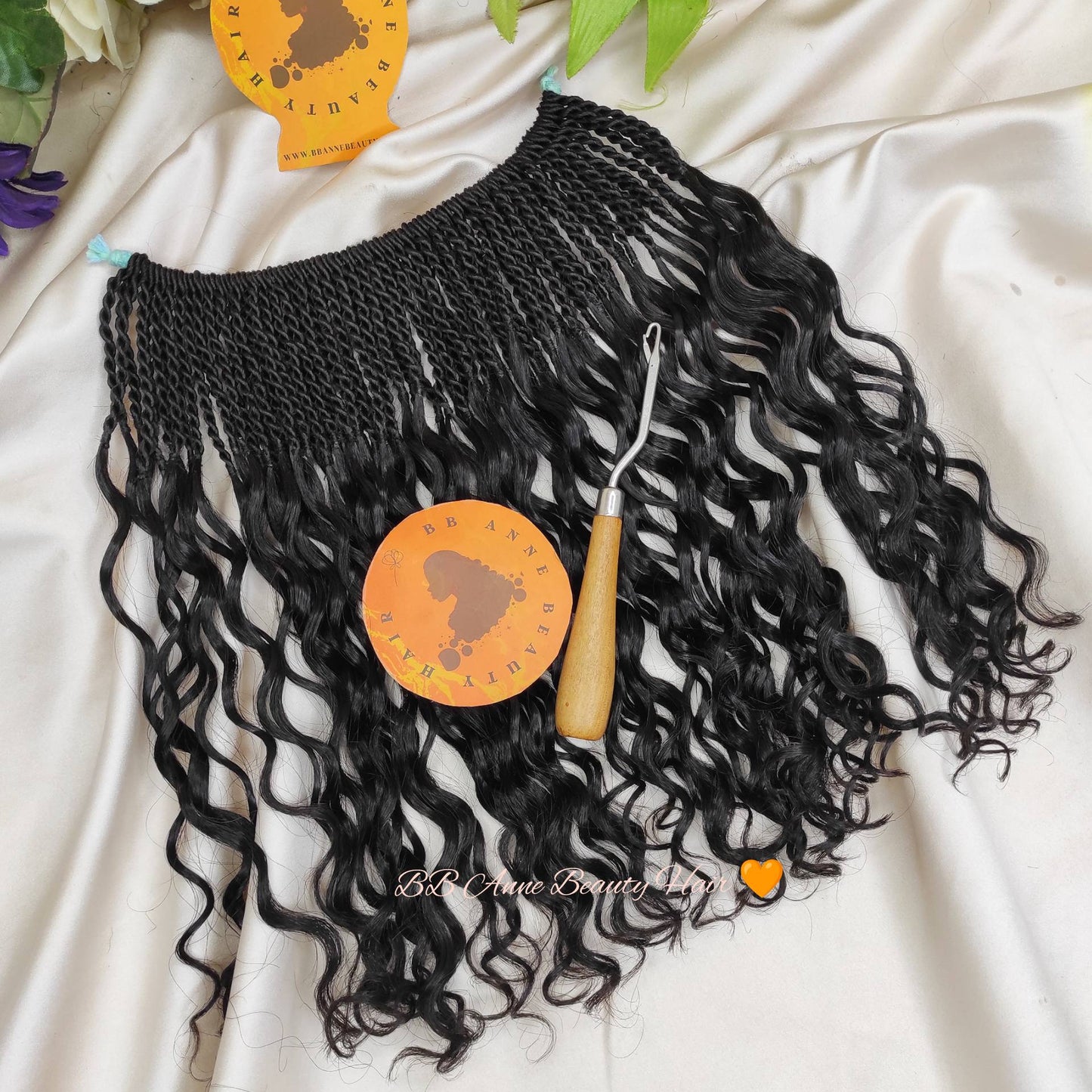 Black twist braided human hair extensions with a crochet hook on a white background