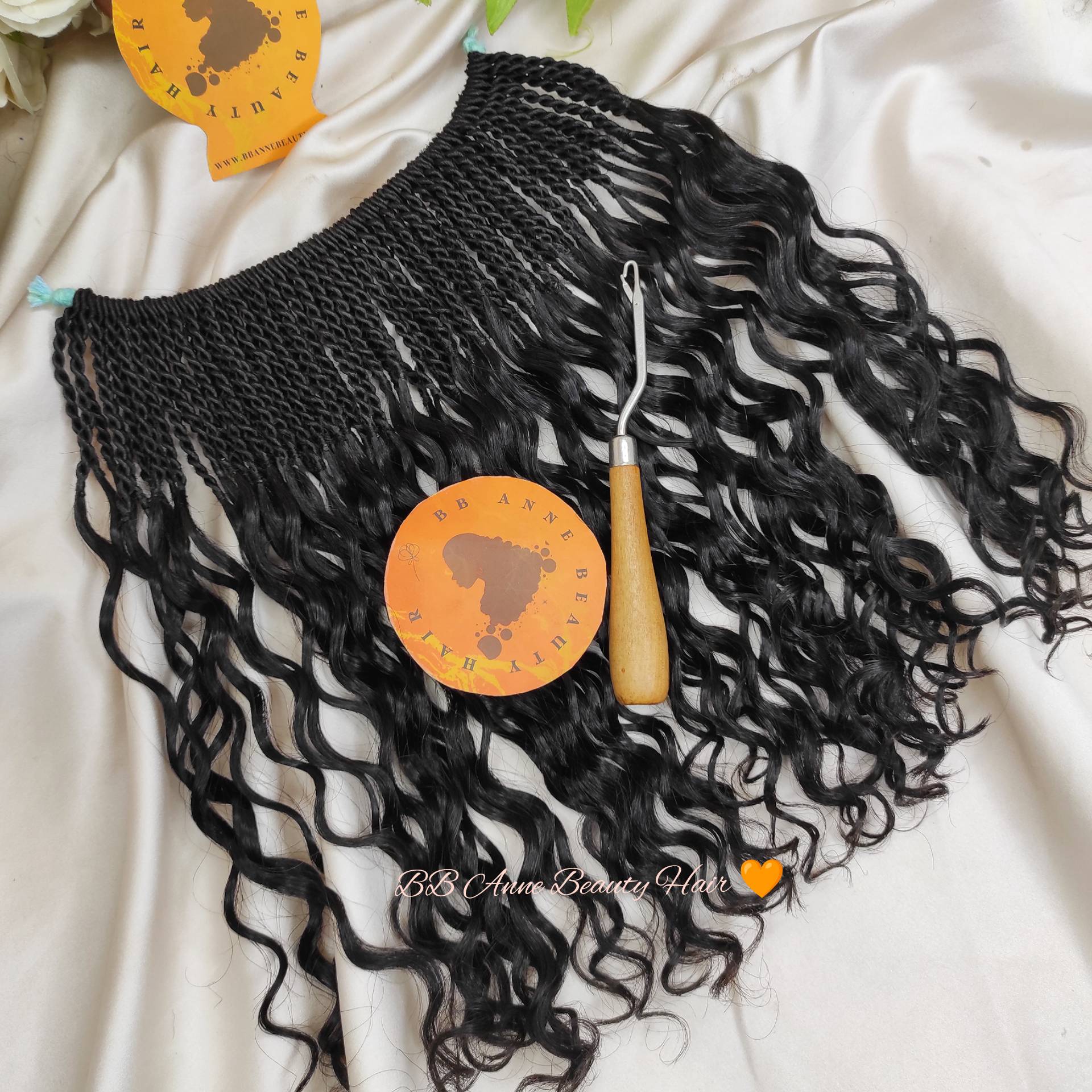 Black braided hair extensions with a crochet hook on a white background, featuring BB Anne Beauty Hair branding.