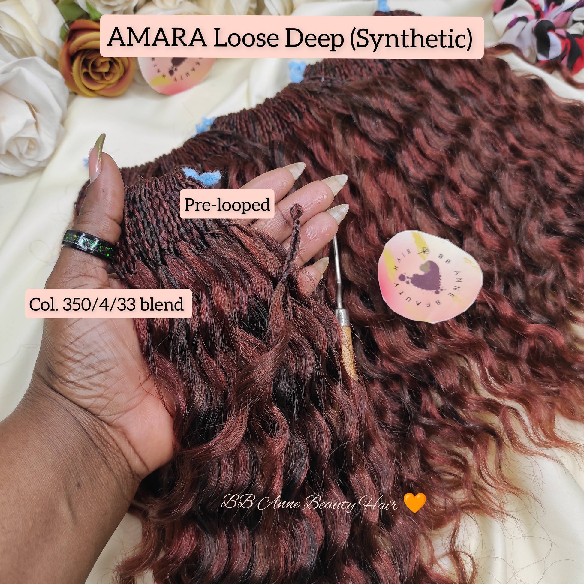 Pre-looped synthetic hair extensions with AMARA Loose Deep color on a hand, surrounded by flowers.