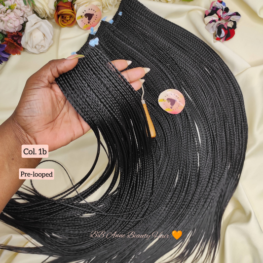 Black microbraids held by a hand with decorative elements and text overlay on a floral background.