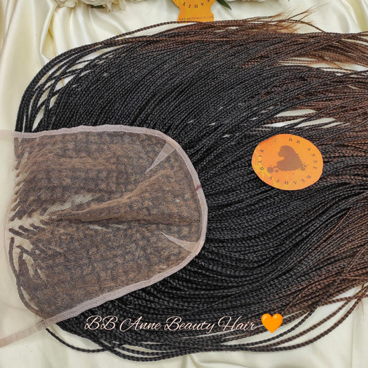 Black braided hair extensions with a lace closure on a white satin surface, branded 'BB Anne Beauty Hair'.