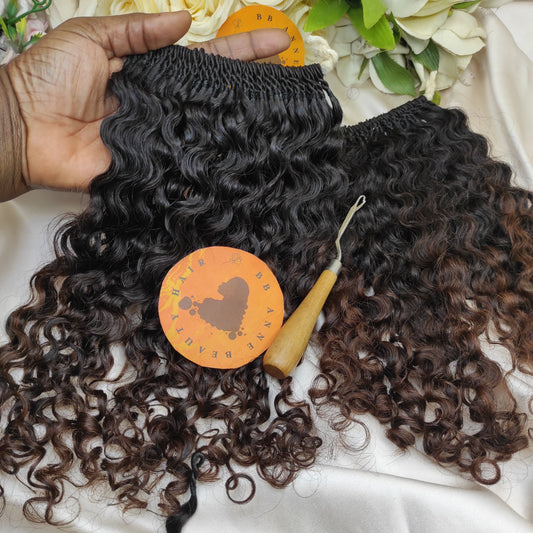Curly hair extensions with a brand logo on a white satin background
