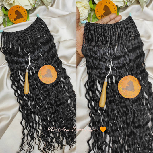 Black hair extensions with a comb on a white fabric background, featuring the brand 'BB Anne Beauty Hair'.