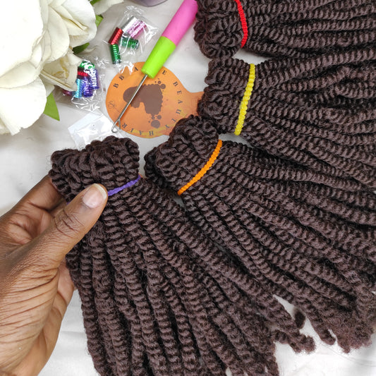 Brown braided hair extensions with a crochet hook and floral decorations on a white background